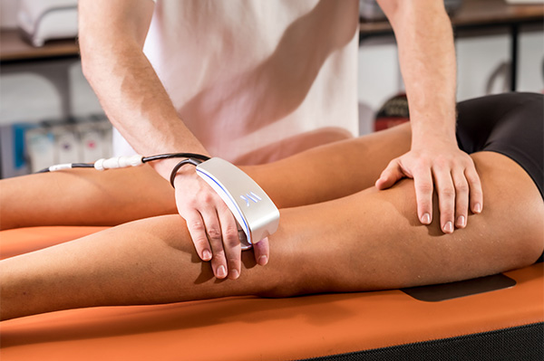 physiotherapist providing a Tecar Therapy treatment to a patient